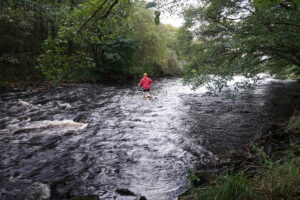 Josh fords the river to a mysterious island